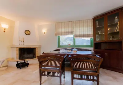a living room with a table and chairs and a fireplace at Augusta Country House in Derés