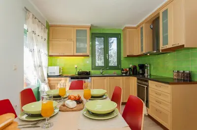 a kitchen with a table with plates and glasses of orange juice at Augusta Country House in Derés