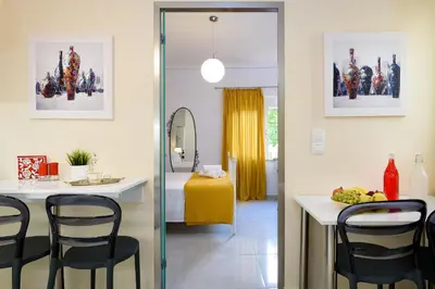 a dining room with a table and chairs in a room at Lithinon House in Chania Town