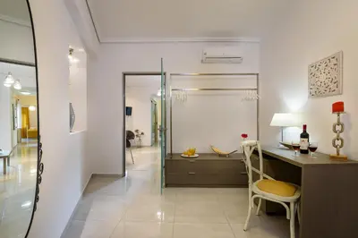 a bathroom with a desk and a glass shower at Lithinon House in Chania Town