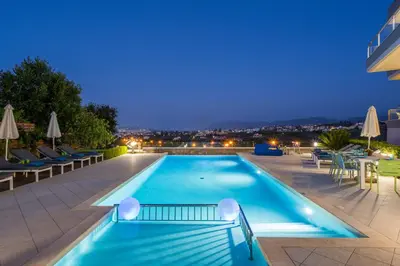 a swimming pool on the roof of a building at night at Elysium Seaview Oasis in Kato Galatas