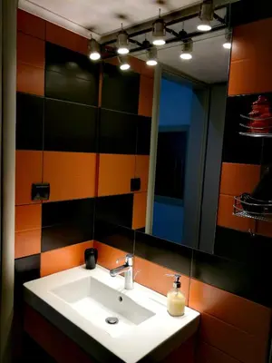 a bathroom with a sink and a mirror at City Square Apartment in Chania Town