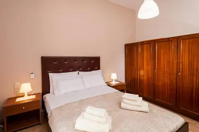 a bedroom with a bed with two towels on it at Falassarna House in Plátanos