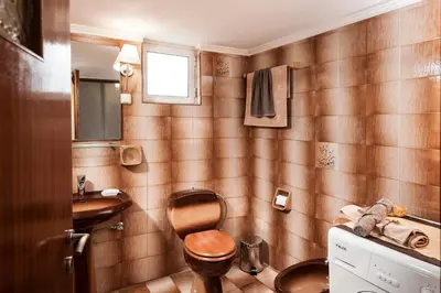 a small bathroom with a toilet and a sink at Falassarna House in Plátanos