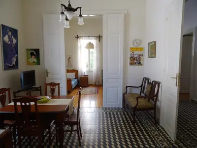 a dining room with a table and chairs in a room at Neoclassical House in Chania Town