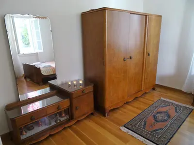 a room with a large wooden cabinet and a mirror at Neoclassical House in Chania Town