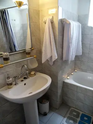a bathroom with a sink and a bath tub at Neoclassical House in Chania Town