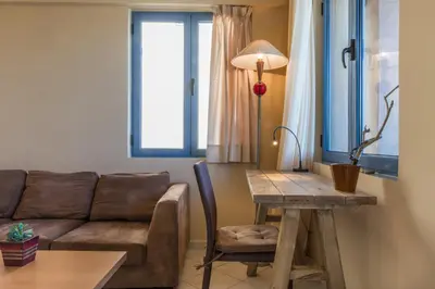 a living room with a couch and a table at Nais Apartments & Studios in Chania Town