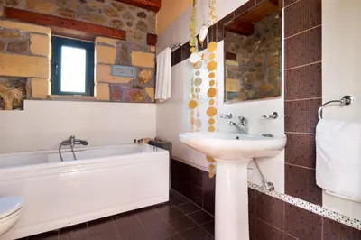 a bathroom with a sink and a bath tub and a sink at Villa Kimothoe with Private Pool, only 20 min to Elafonissi Beach in AmigdhalokeFálion
