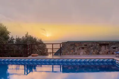 a pool with a view of the ocean at sunset at Villa Kimothoe with Private Pool, only 20 min to Elafonissi Beach in AmigdhalokeFálion