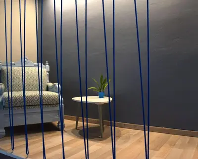 a room with a chair and a table with a plant at Evaris Apartments in Chania Town