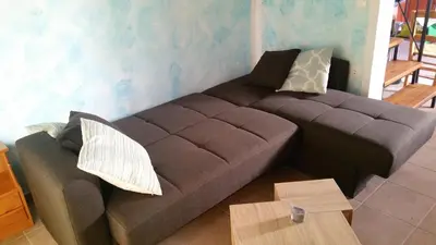 a brown couch sitting in a living room at Villa Afou in Afráta
