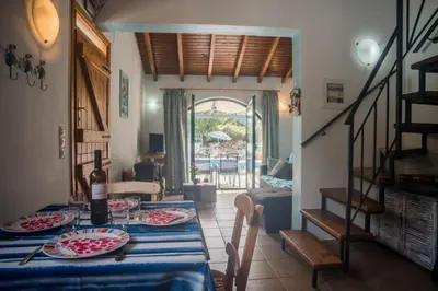 a dining room with a table with a blue table cloth at Villa Afou in Afráta