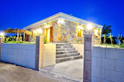 a stone house with stairs and lights on it at Iridanos Villa in Kissamos