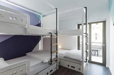 two bunk beds in a room with a window at Cocoon City Hostel in Chania Town