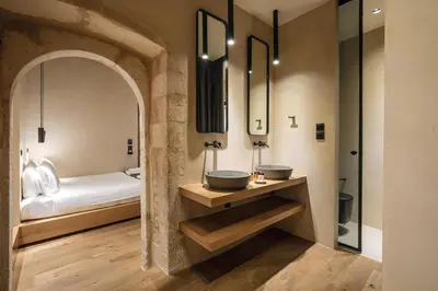 a bathroom with two sinks and a bed at Monastery Estate Venetian Harbor in Chania Town