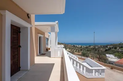 a balcony with a view of the ocean at Nikola's Villa Stalos Chania in Stalos