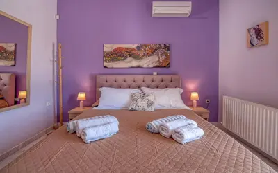 a bedroom with a large bed with two pillows on it at Nikola's Villa Stalos Chania in Stalos