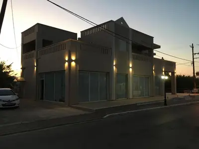 a building with a car parked in front of it at Mini Art Apartments in Gerani Chanion