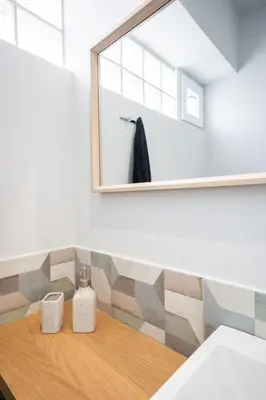 a bathroom with a mirror and a wooden table at Villa Giota in Chania Town