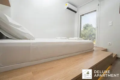 a bedroom with a bed with a large window at Nikis Dream Comfy Apartments in Chania Town