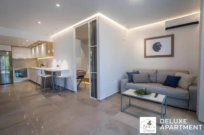 a living room with a couch and a table at Nikis Dream Comfy Apartments in Chania Town