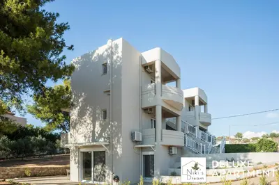 a white building with a sign in front of it at Nikis Dream Comfy Apartments in Chania Town