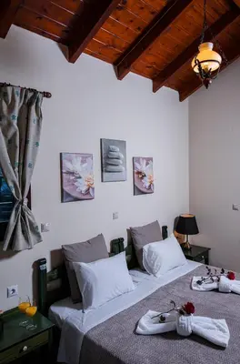 a bedroom with two beds with towels on them at Kyriaki's Cozy Apartments in Agia Marina Nea Kydonias