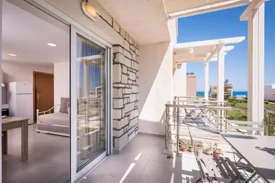 a balcony with a view of the ocean at Athina Apartments Near The Sea Platania in Plataniás
