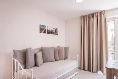a white couch in a living room with a window at Athina Apartments Near The Sea Platania in Plataniás