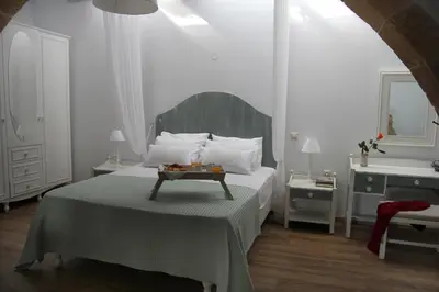 a bedroom with a bed with a table on it at Villa Meli-milon in Kolymvari