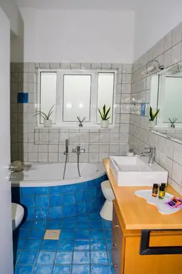 a bathroom with a tub and a toilet and a sink at Elia Seaside Villa, Amazing 2-Story Eco Pool House! in Kissamos