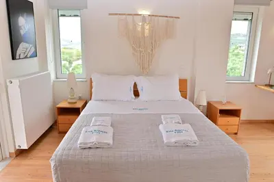 a bedroom with a bed with two towels on it at Elia Seaside Villa, Amazing 2-Story Eco Pool House! in Kissamos