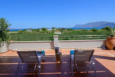 two chairs and a vase on a balcony with a view at Elia Seaside Villa, Amazing 2-Story Eco Pool House! in Kissamos