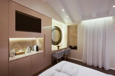 a hotel room with a bed and a sink and a mirror at Consolato Boutique in Chania Town