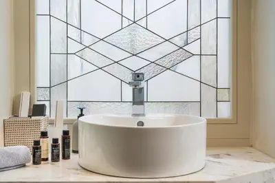 a white sink in a bathroom with a window at Consolato Boutique in Chania Town