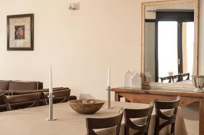 a dining room with a table and chairs and a mirror at Villa Stellina in Marathokefála