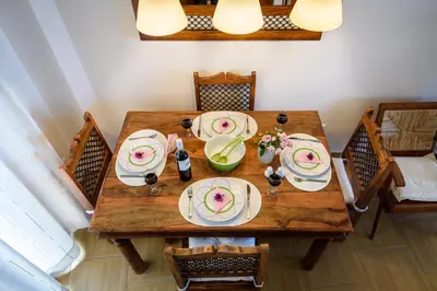 an overhead view of a wooden table with plates of food at Platanias Sky View in Plataniás