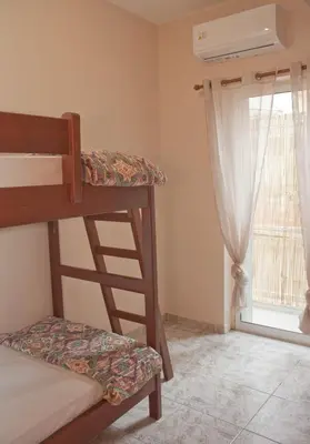 a bedroom with two bunk beds and a window at Danaos Hotel in Chania Town