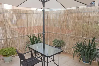 a table and chair with an umbrella on a patio at Danaos Hotel in Chania Town