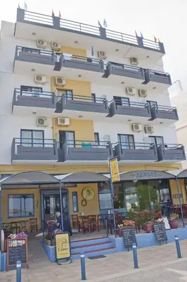 a building with tables and chairs in front of it at Danaos Hotel in Chania Town