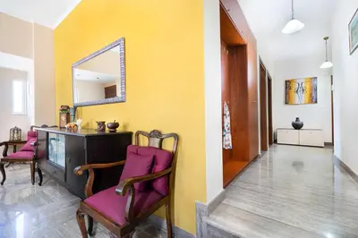 a hallway with a table and chairs and a mirror at Vrahokipos Villa in Kounoupidhianá