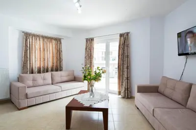 a living room with two couches and a table at Chania Sea View Apartment with Free Private Parking in Chania Town