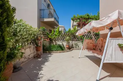 a swing on a patio in a house at Villa Nopigia Somina in Kissamos