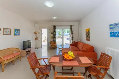 a living room with a table with fruit on it at Villa Nopigia Somina in Kissamos