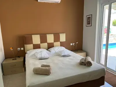 a bedroom with a bed with towels on it at Villa Nopigia Somina in Kissamos