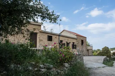 an old building with flowers in front of it at Lithari in Kámboi