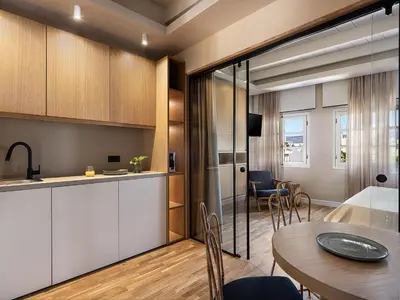 a kitchen and dining room with a table and chairs at Lithinon Luxury Suites with Free Parking in Chania Town