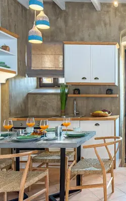 a kitchen with a table with wine glasses on it at Lithinon Luxury Suites with Free Parking in Chania Town
