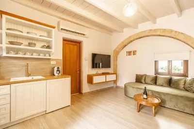 a living room with a couch and a table at Lithinon Luxury Suites with Free Parking in Chania Town